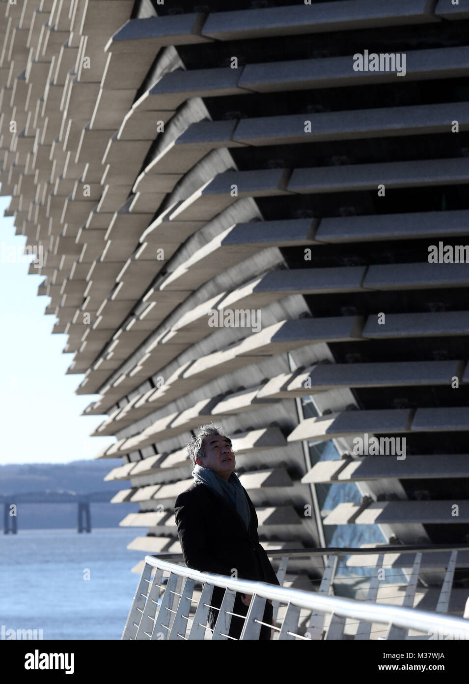Japanese architect Kengo Kuma as he views the finished exterior of the new eighty million pound V&amp;A Dundee museum for the first time. The designer met workers as the focus moves to the interior of the V&amp;A, fitting out gallery spaces, a cafe and a restaurant ahead of its opening in September. Stock Photo