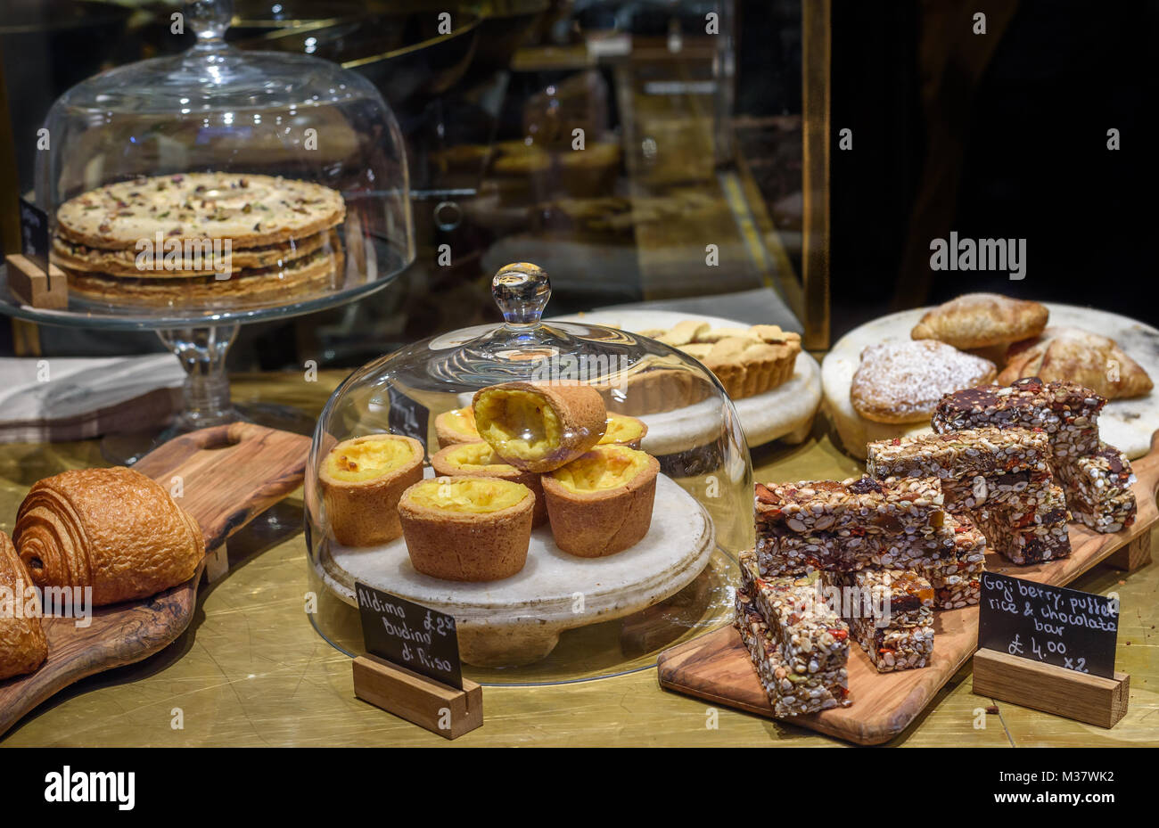 Various cakes and pastries on display in a shop Stock Photo Alamy
