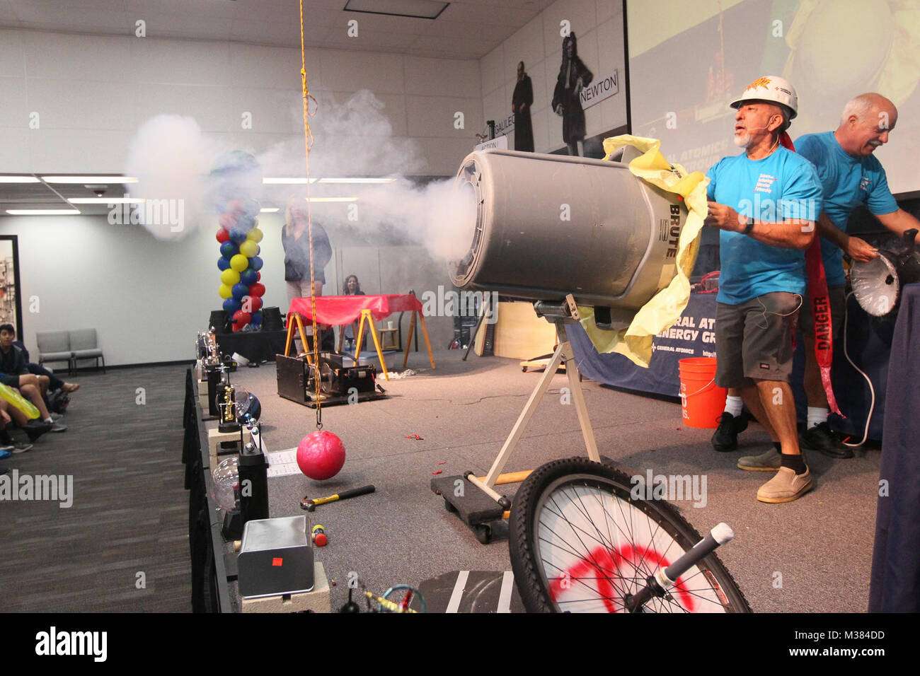 171004-N-HW977-193 RIVERSIDE, Calif. (Oct. 4, 2017) Rigo Brambila, a General Atomics Group (GA) technician, left, and Rick Lee, a GA scientist, launch smoke rings at the audience during the 18th annual Science Technology Education Partnership (STEP) Conference. Attended by thousands of elementary and middle school students from throughout Southern California's Inland Empire, NSWC Corona's participation supports the Navy's strategy to inspire, engage and educate the next generation of scientists and engineers. (U.S. Navy photo by Greg Vojtko/Released) 171004-N-HW977-193 by NAVSEA Corona Stock Photo