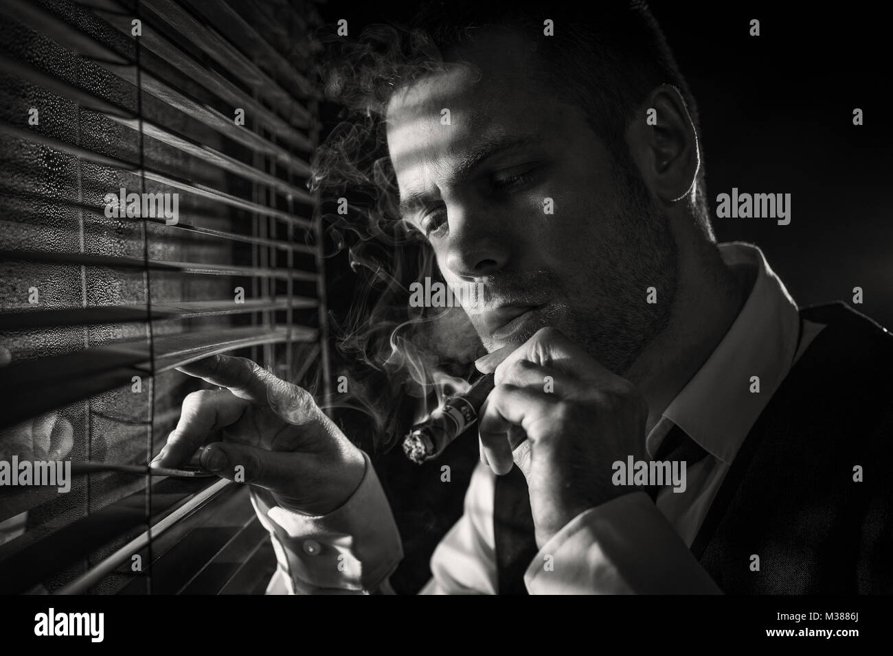 Gangster smoking a cigar while looking out the window at a car