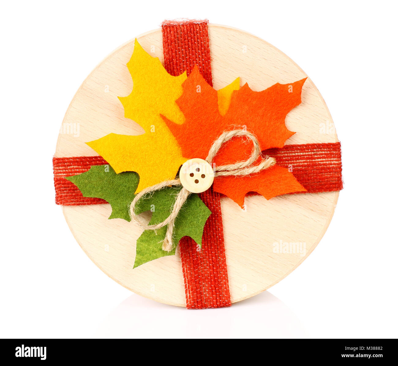 Autumn concept of present box with dried leaves on white backround Stock Photo