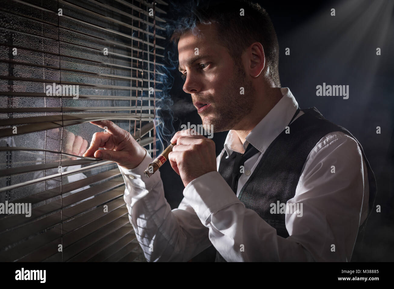 Gangster smoking a cigar while looking out the window at a car