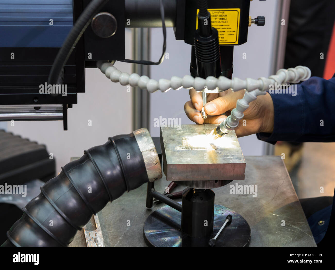 The operator use the laser welding machine.The hi-precision welding process  Stock Photo - Alamy