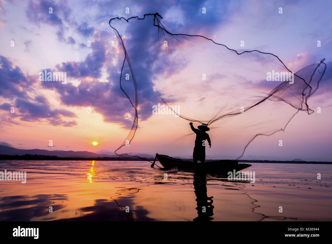 Soft focus and Fisherman of Bangpra Lake in action for fishing Thailand