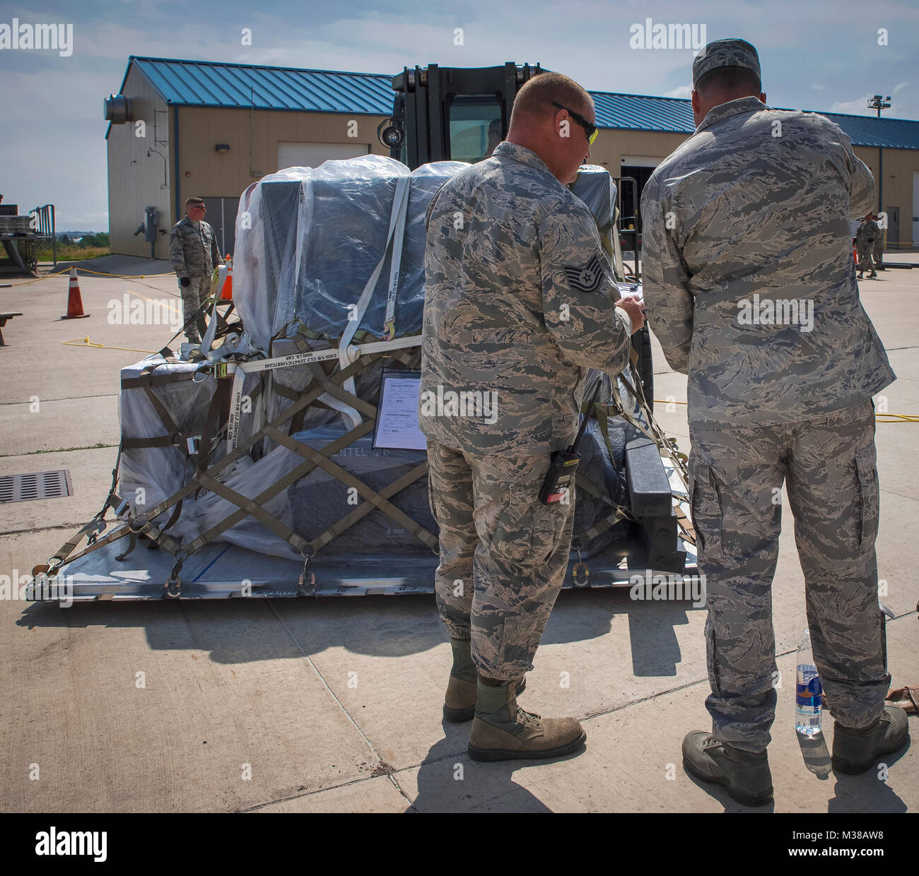 Tech. Sgt. Thomas Kidder, air transportation supervisor, left, checks