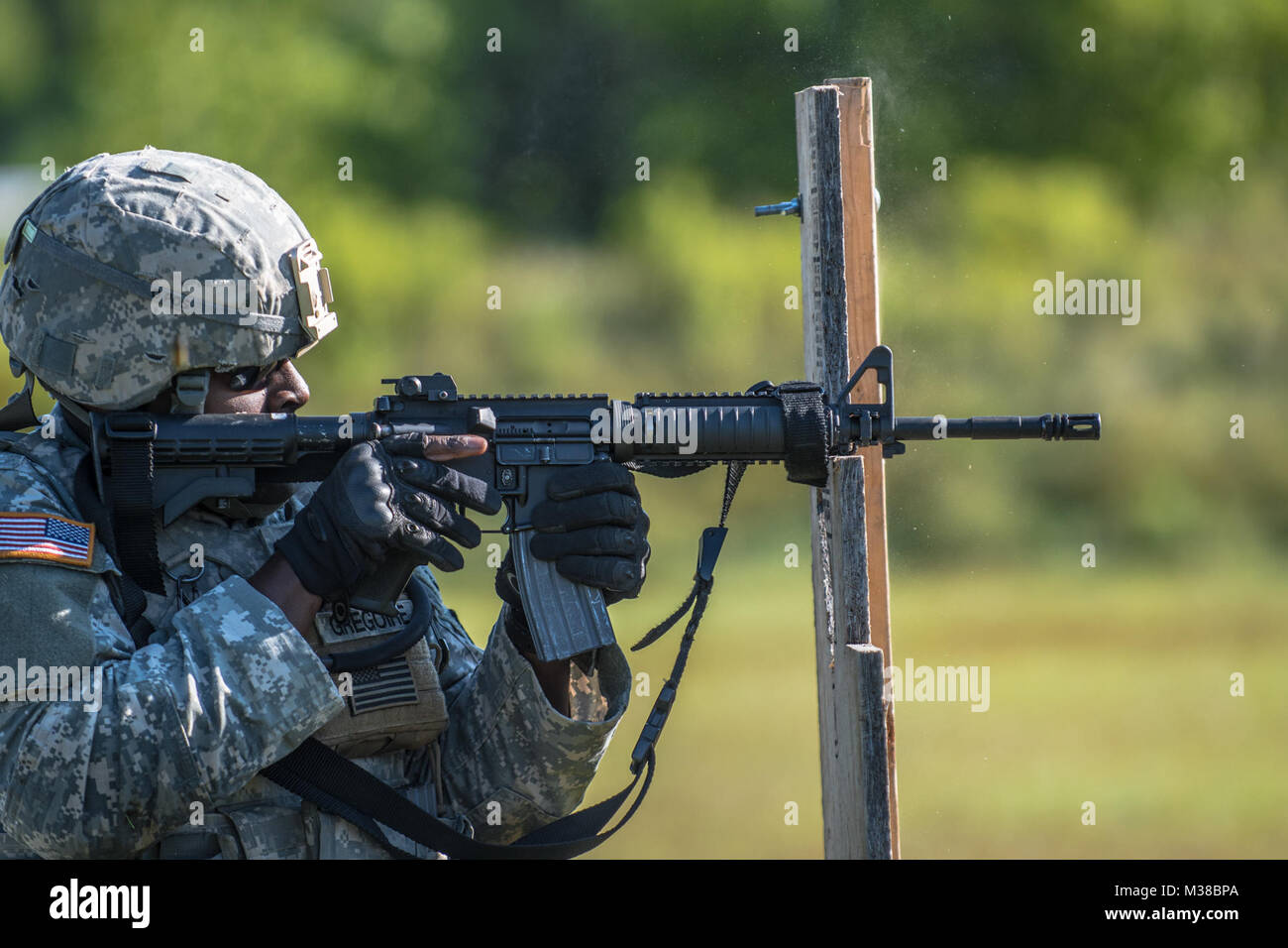 Sgt. Tookie Gregoire a combat engineer with the 251st Engineer Company (Sapper) positions his M4 Carbine during a reflexive fire exercise at Canadian Forces Base Gagetown in New Brunswick, Canada, August 14th, 2017. The reflexive fire range tests the Soldiers on their ability to shoot from various firing positions while moving from target to target in a tactical manner. 170814-Z-JY390-4 by Maine Army National Guard Stock Photo