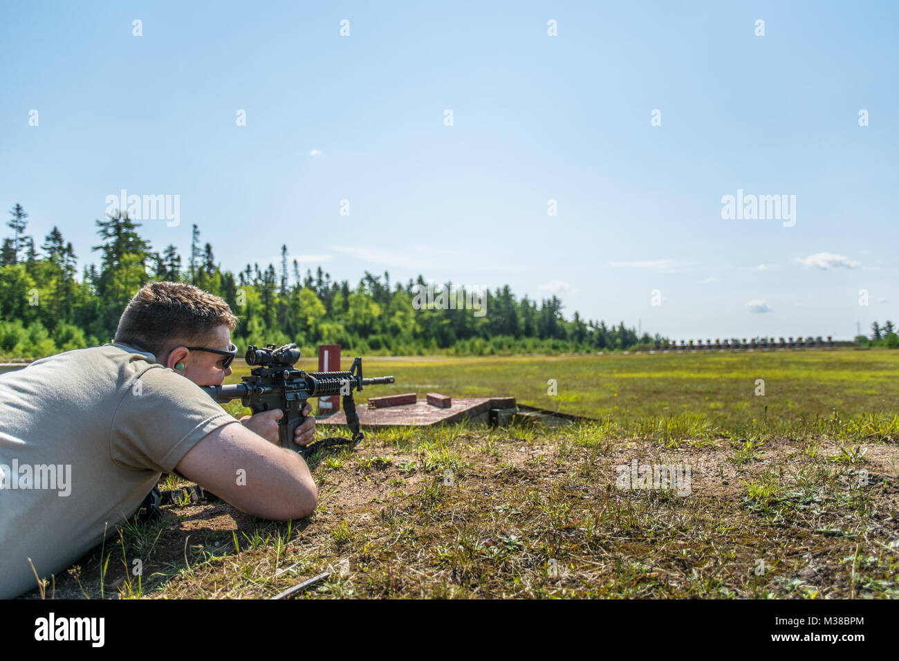 Spc. Ian May a combat engineer with the 251st Engineer Company (Sapper) takes aim with his M4 Carbine during a stress shoot at Canadian Forces Base Gagetown in New Brunswick, Canada,  August 14th, 2017. The stress shoot combined long distance target engagement with physically fatiguing tasks while being timed. “Soldiers need to understand that when your actually under stress a lot of things change, your hear rate, your breathing, everything changes and it makes it a lot more difficult to hit your target,” said Spc. Jeffery Waters a combat engineer with the 251st and the marksmanship subject ma Stock Photo