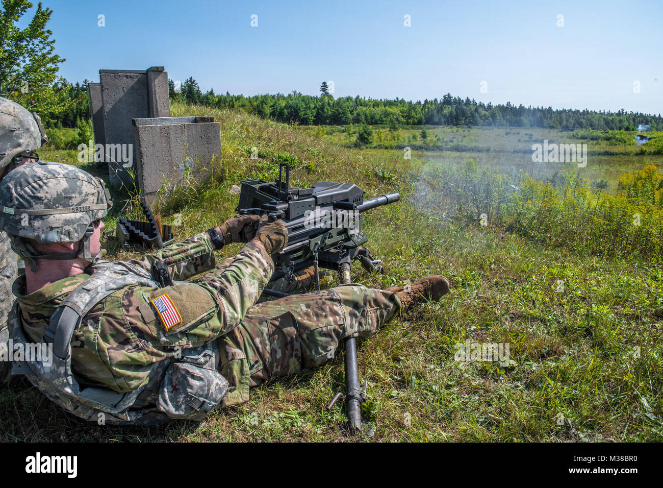 Spc. Brendan Sugrue of the 251st Engineer Company (Sapper) sends a volley of 40mm grenade rounds downrange at Canadian Forces Base Gagetown in New Brunswick, Canada on August 14th, 2017. 170814-Z-JY390-11 by Maine Army National Guard Stock Photo