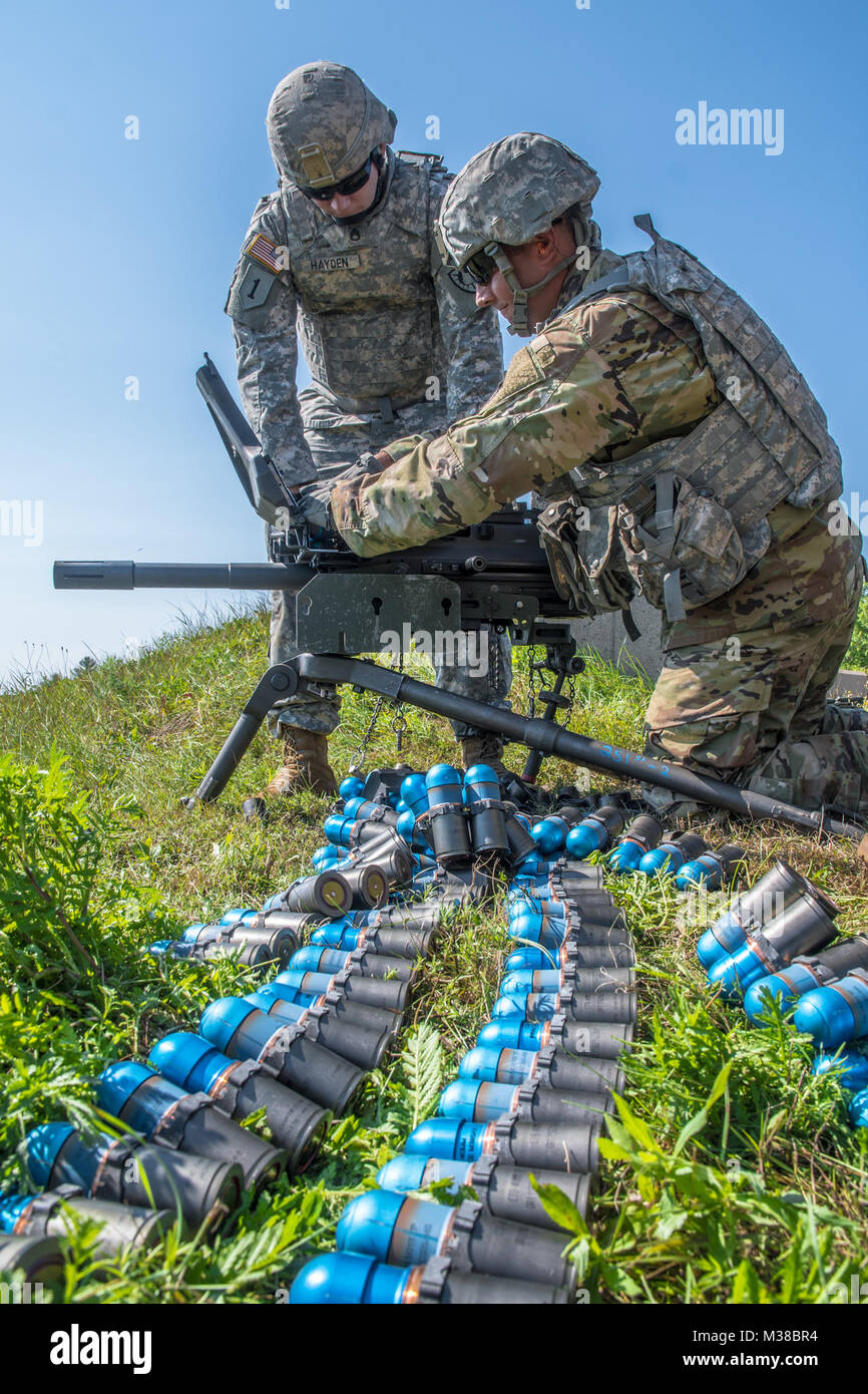 Sgt. 1st Class Jashaab Leland and Staff Sgt. Thomas Hayden, combat engineers with the 251st Engineer Company (Sapper) reload a MK19 at Canadian Forces Base Gagetown in New Brunswick, Canada, August 14th, 2017. 170814-Z-JY390-12 by Maine Army National Guard Stock Photo