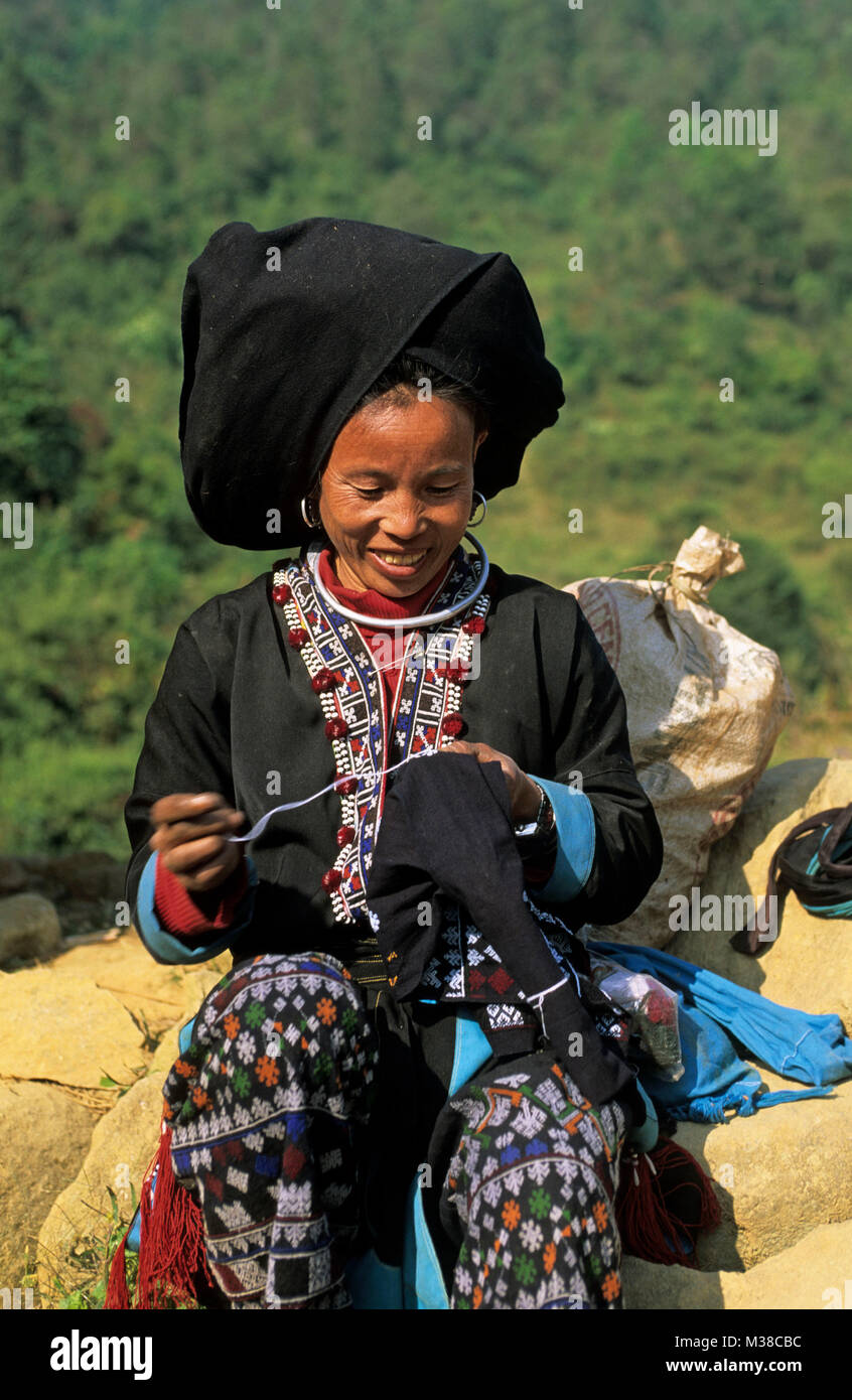 Vietnam. Sapa. Woman of Dao hilltribe embroidering own clothing. Stock Photo