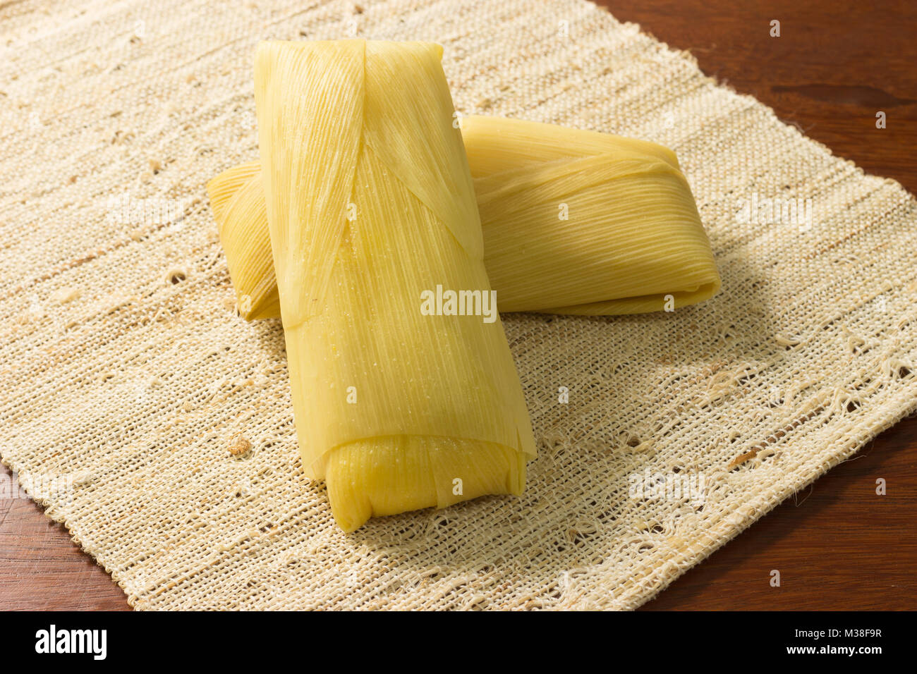 Pamonha, canjica/curau tradicional brazilian food. Tasty and delicius. Cheap street food, Eat in the breakfast or afternoon snack. made with corn Stock Photo