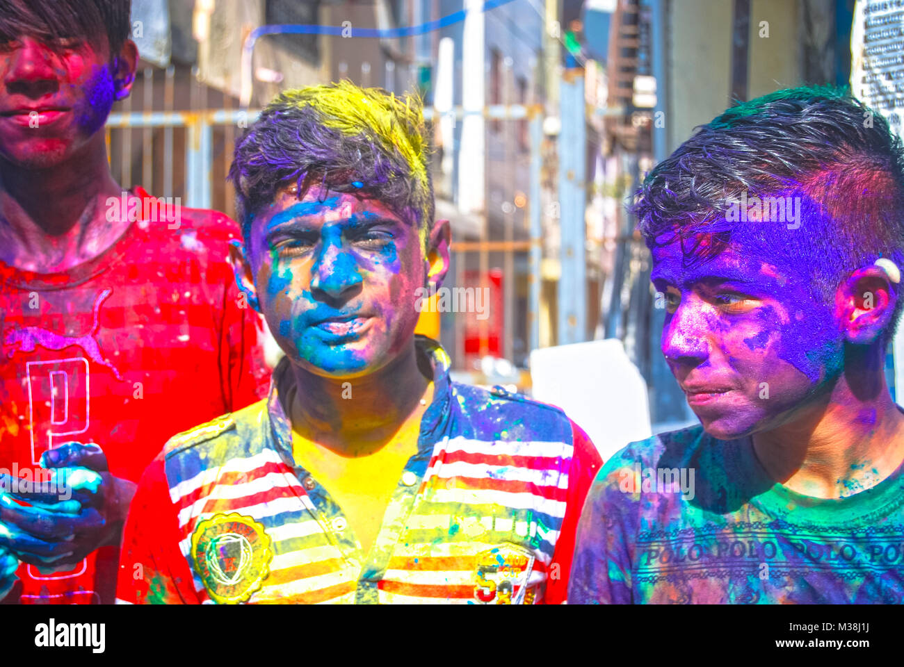 A group of teenage boys covered in powder paint during the celebration of the Hindu spring festival Holi in New Delhi, India. Stock Photo