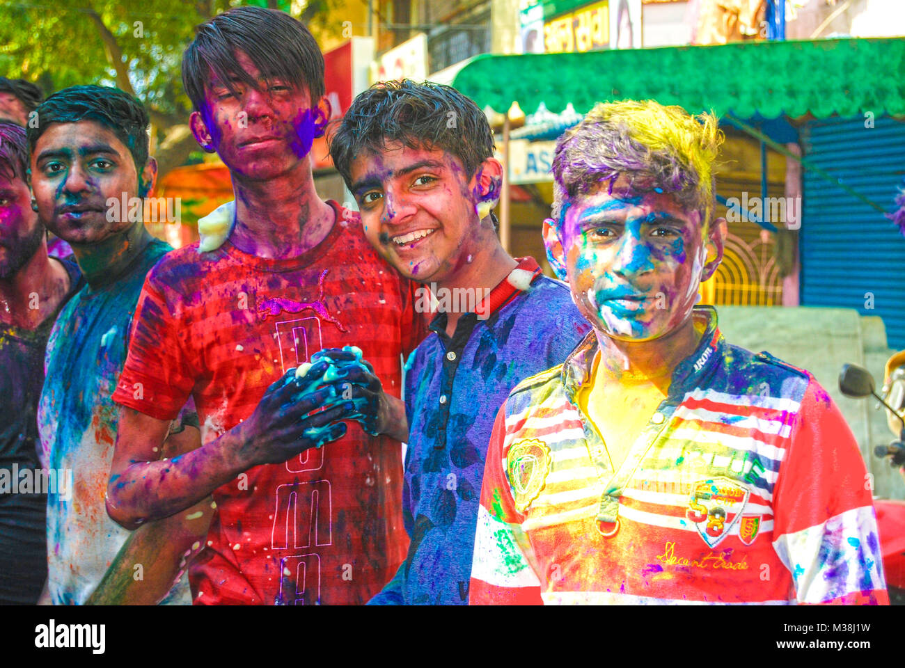 A group of teenage boys covered in powder paint during the celebration of the Hindu spring festival Holi in New Delhi, India. Stock Photo