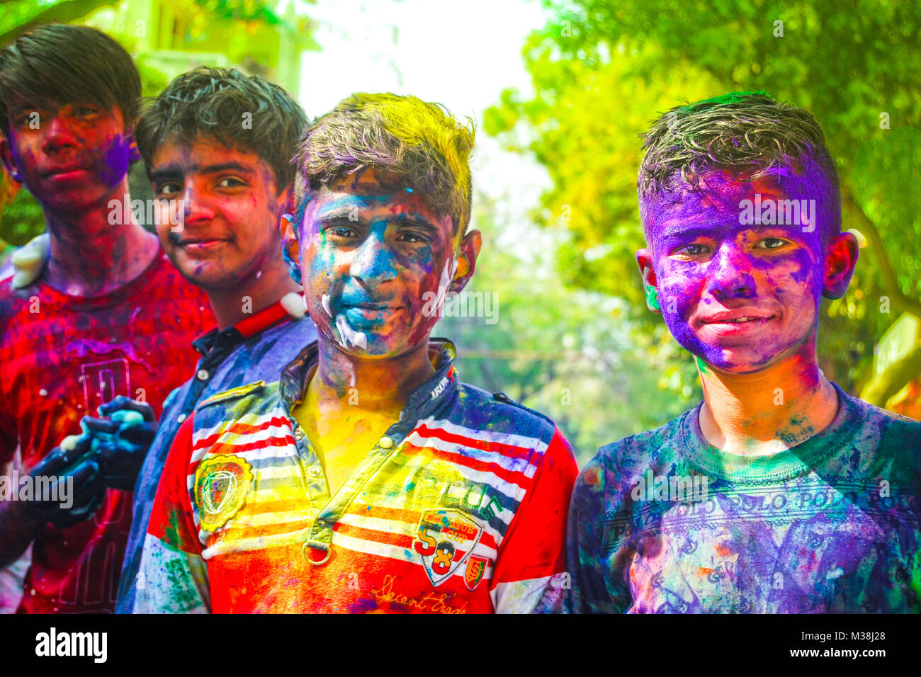 A group of teenage boys covered in powder paint during the celebration of the Hindu spring festival Holi in New Delhi, India. Stock Photo