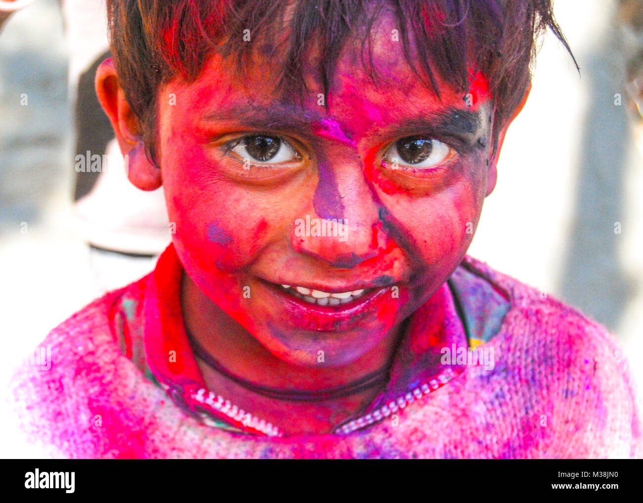 A little boy covered in powder paint during the celebration of the Hindu spring festival Holi in New Delhi, India. Stock Photo