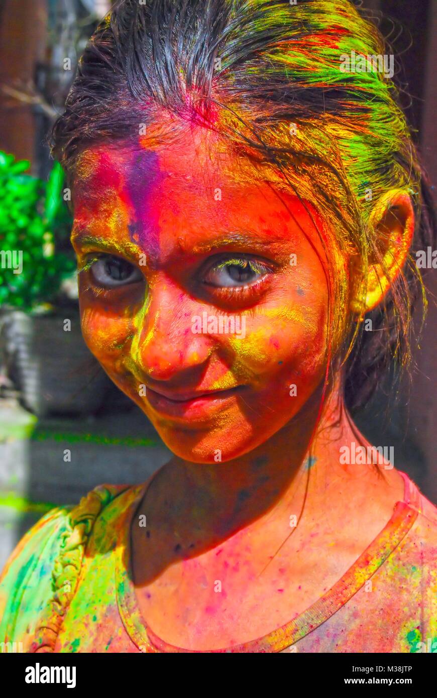 A little girl covered in powder paint during the celebration of the Hindu spring festival Holi in New Delhi, India. Stock Photo