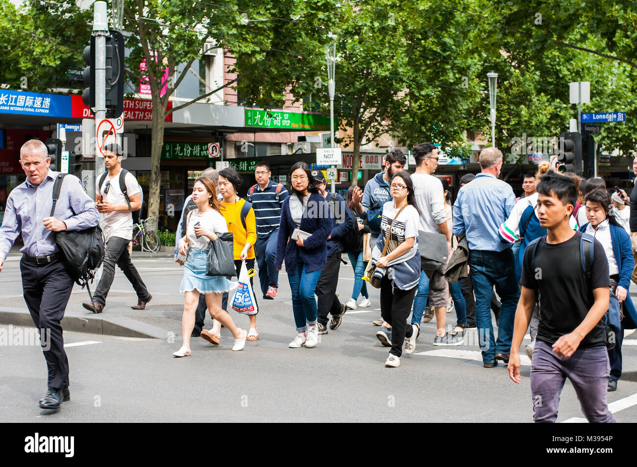 Pedestrians crossing Lonsdale Street at corner with Swanston Street, Melbourne, Australia Stock Photo