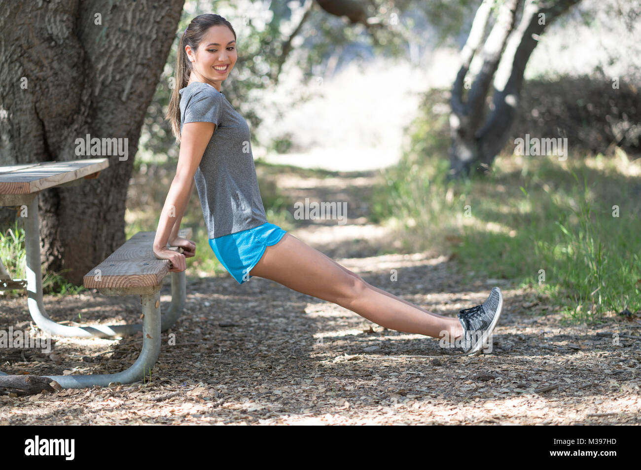 Female outdoor stretching on bench fitness Stock Photo Alamy
