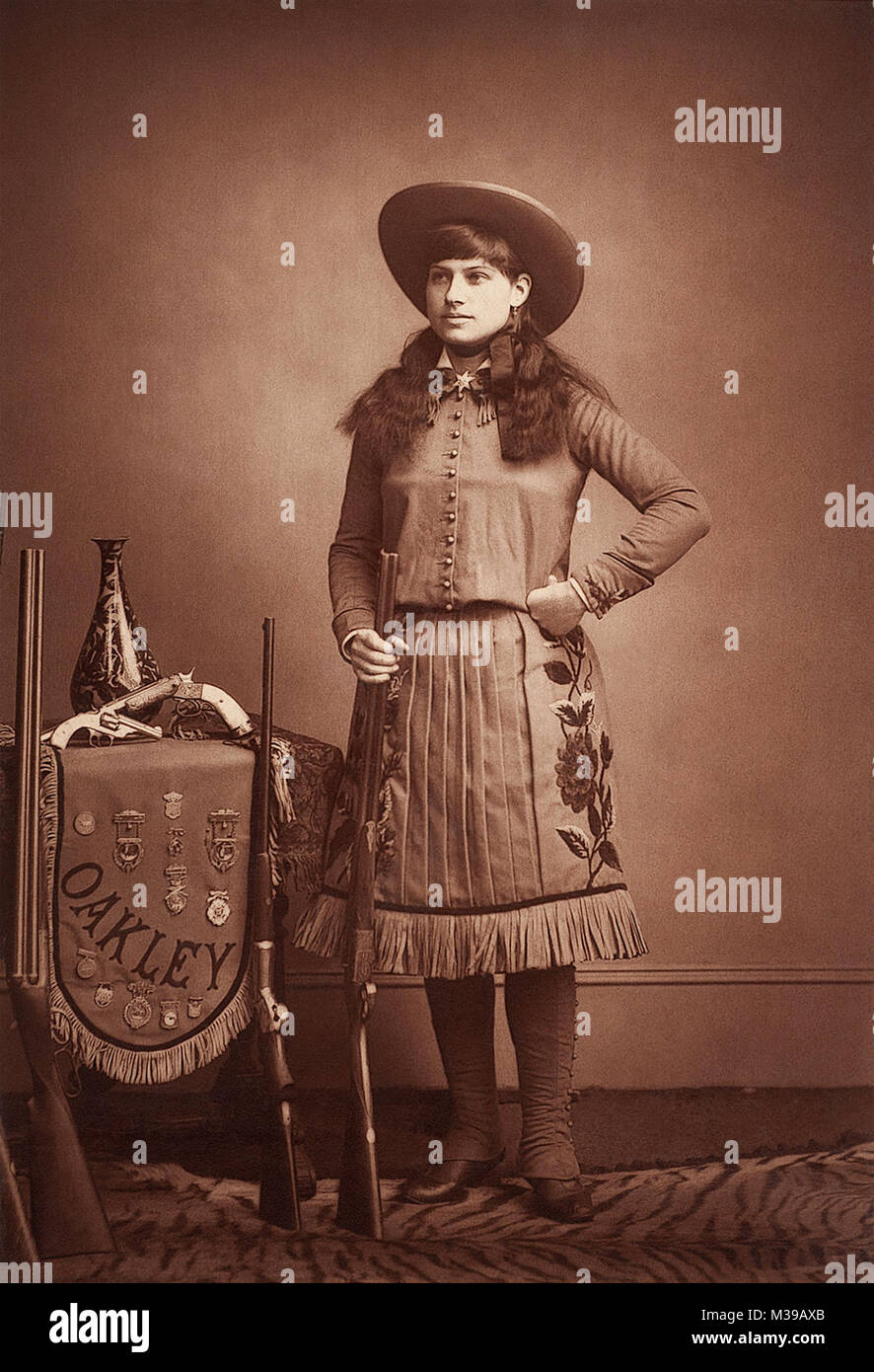 Annie Oakley (1860-1926) was an outstanding American sharpshooter who became famous while performing in Buffalo Bill's Wild West Show. Photo c1887-1880s by Elliott & Fry, London, England. Stock Photo