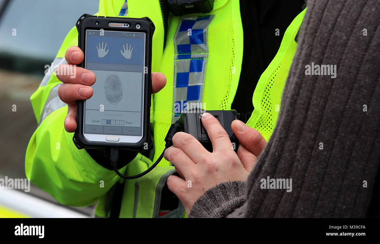 A West Yorkshire Police officer holding a new mobile fingerprint