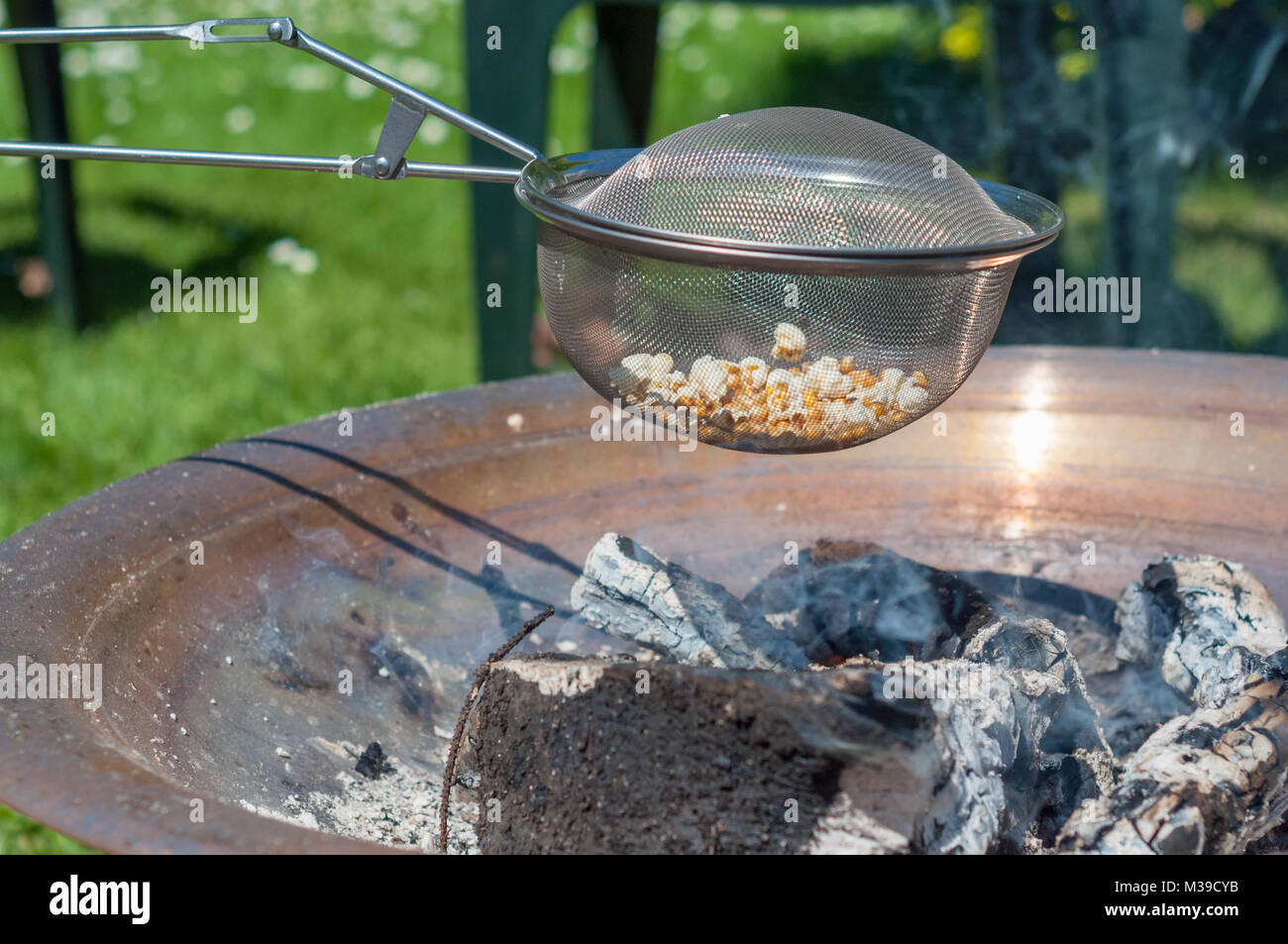 Popcorn over open fire on a warm day Stock Photo Alamy