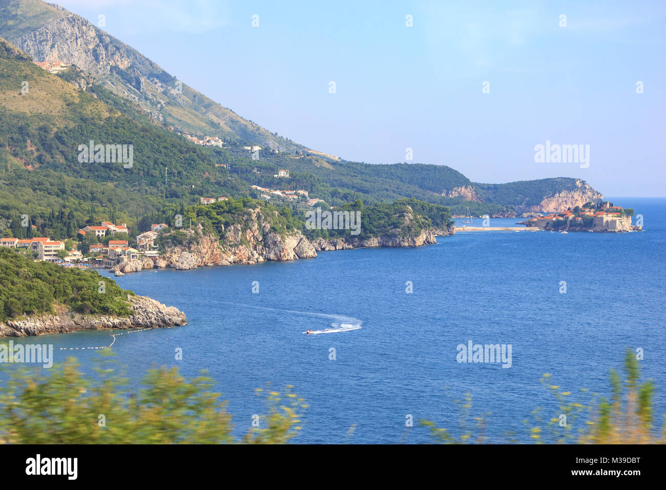 View of the sea bays, the Przno city and the island of Sveti Stefan in Montenegro from the bus passing along the seacoast Stock Photo