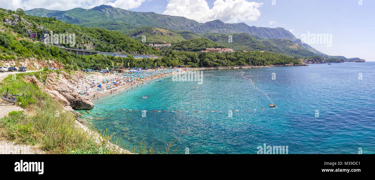 PRZNO, BUDVA RIVIERA AREA, MONTENEGRO, AUGUST 2, 2014: Panoramic view of the largest beach with many people in lagoon in Przno city Stock Photo