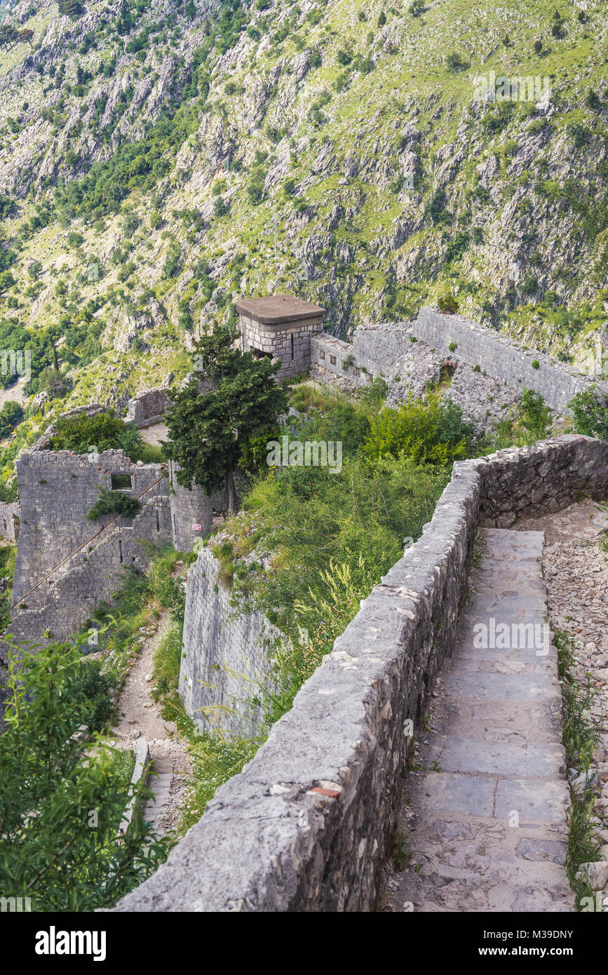 Remains of walls of Saint John Fortress on the mount aobve Kotor coastal city, located in Bay of Kotor of Adriatic Sea, Montenegro Stock Photo