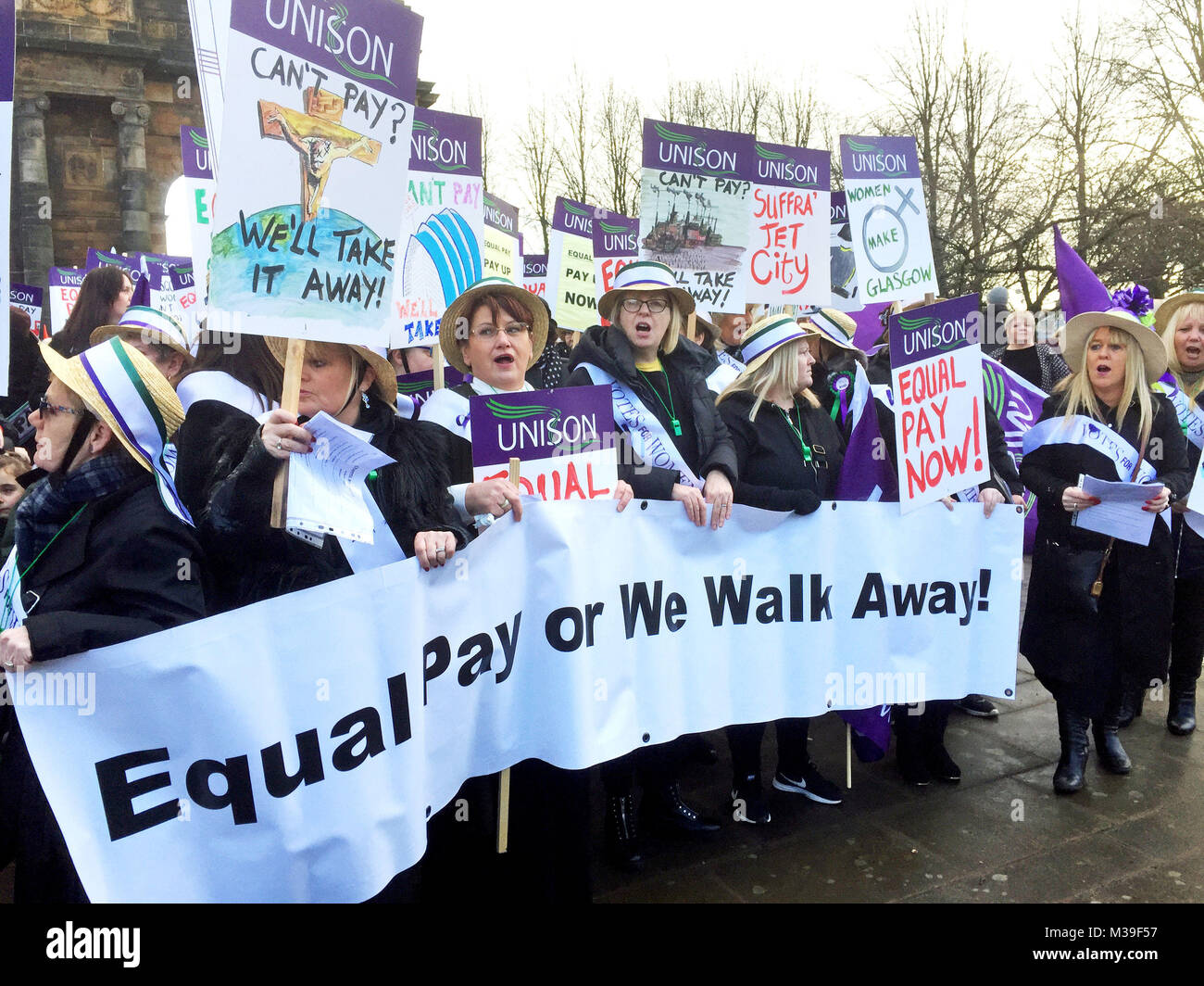 Hundreds of women, some dressed as suffragettes, march through Glasgow calling for equal pay from the city council. Stock Photo