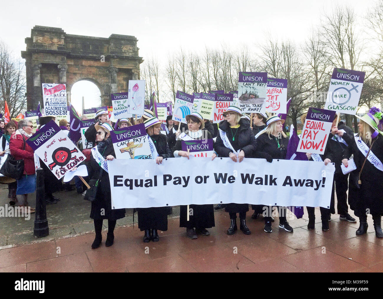 Hundreds of women, some dressed as suffragettes, march through Glasgow calling for equal pay from the city council. Stock Photo