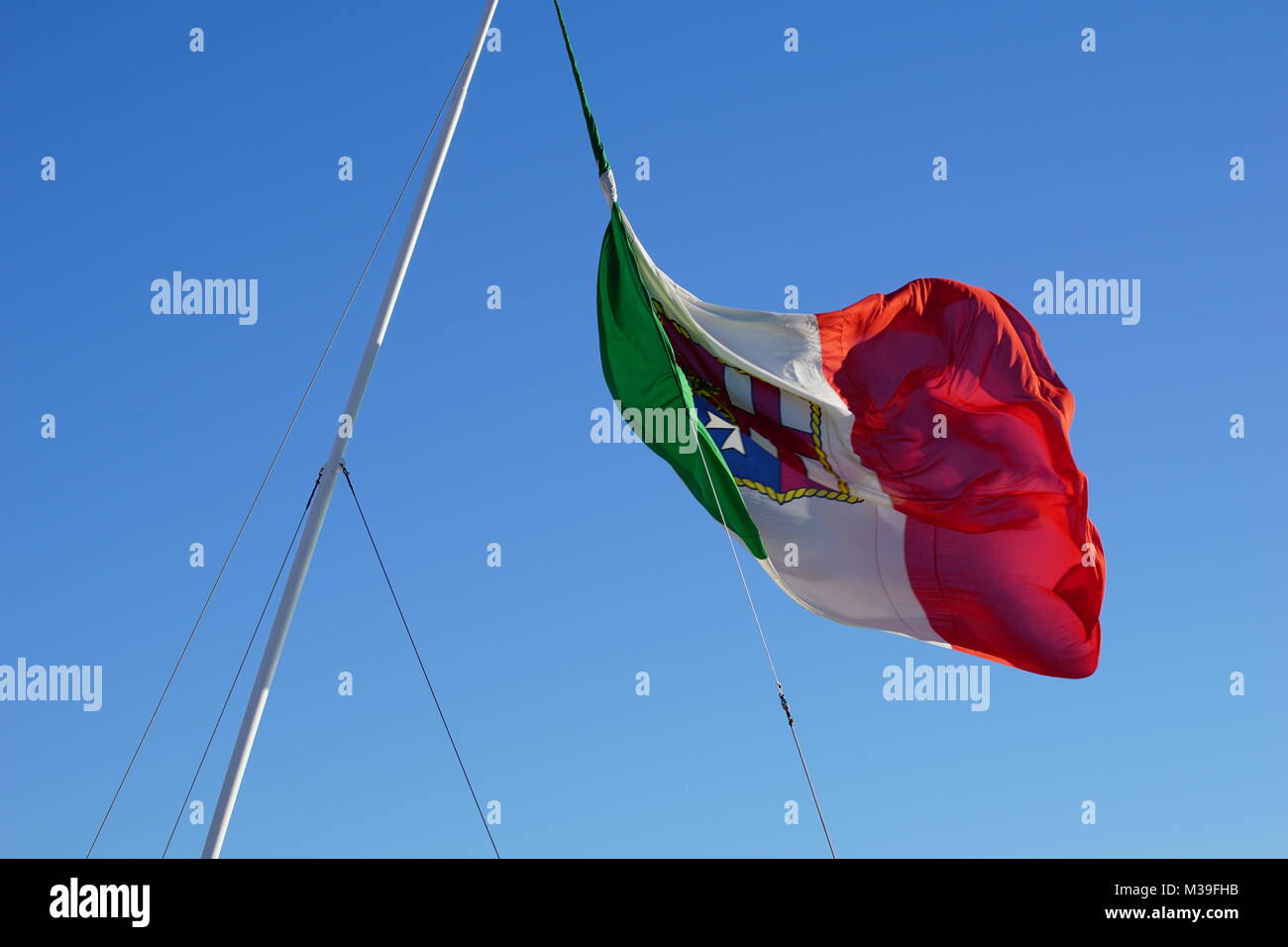 Italy flag with coat of arms on a cruising ship Stock Photo