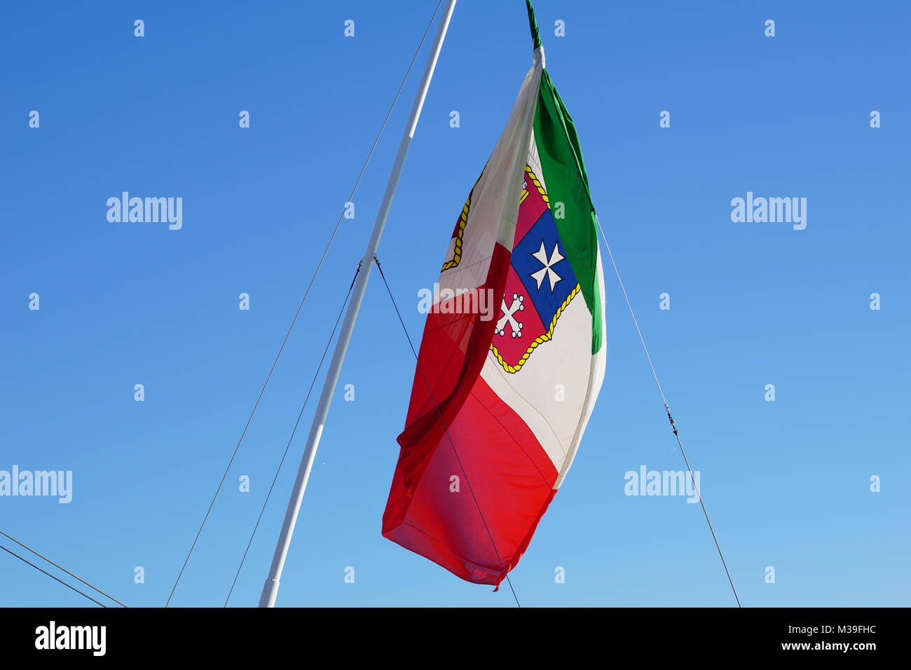 Italy flag with coat of arms on a cruising ship Stock Photo