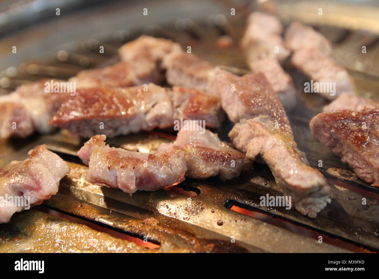 Korean grilled pork BBQ (Samgyeopsal-gui) with charcoal at Korean restaurant, Busan, South Korea Stock Photo