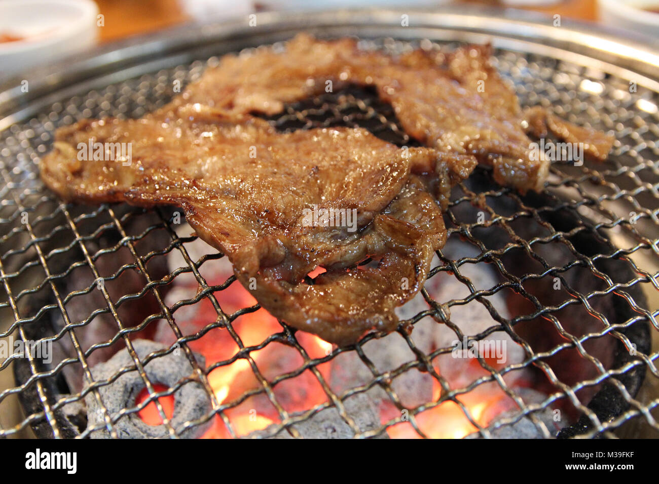 Korean grilled pork BBQ (Samgyeopsalgui) with charcoal at Korean