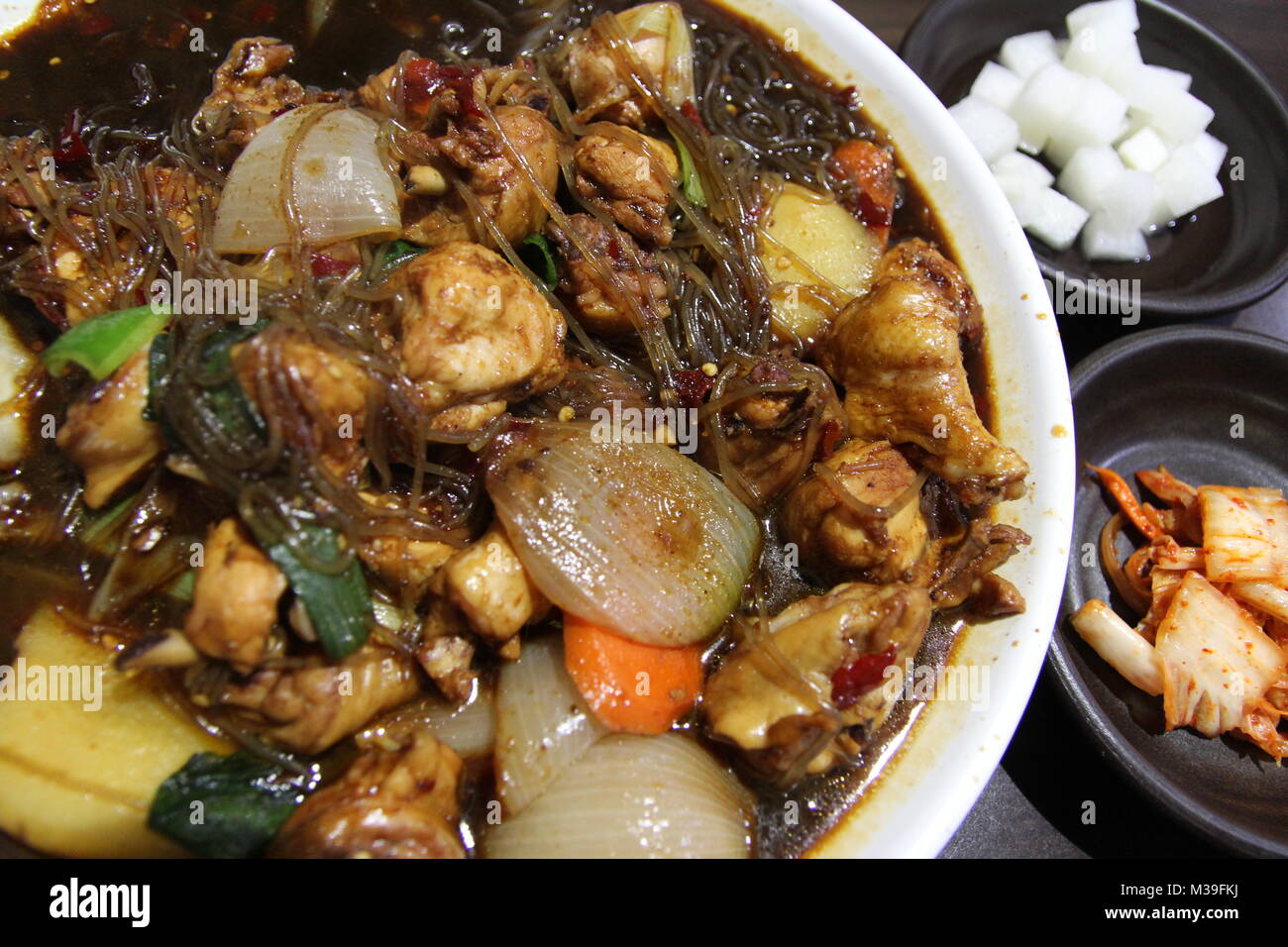 Korean chicken stew with soy sauce, glass noodles and vegetables at
