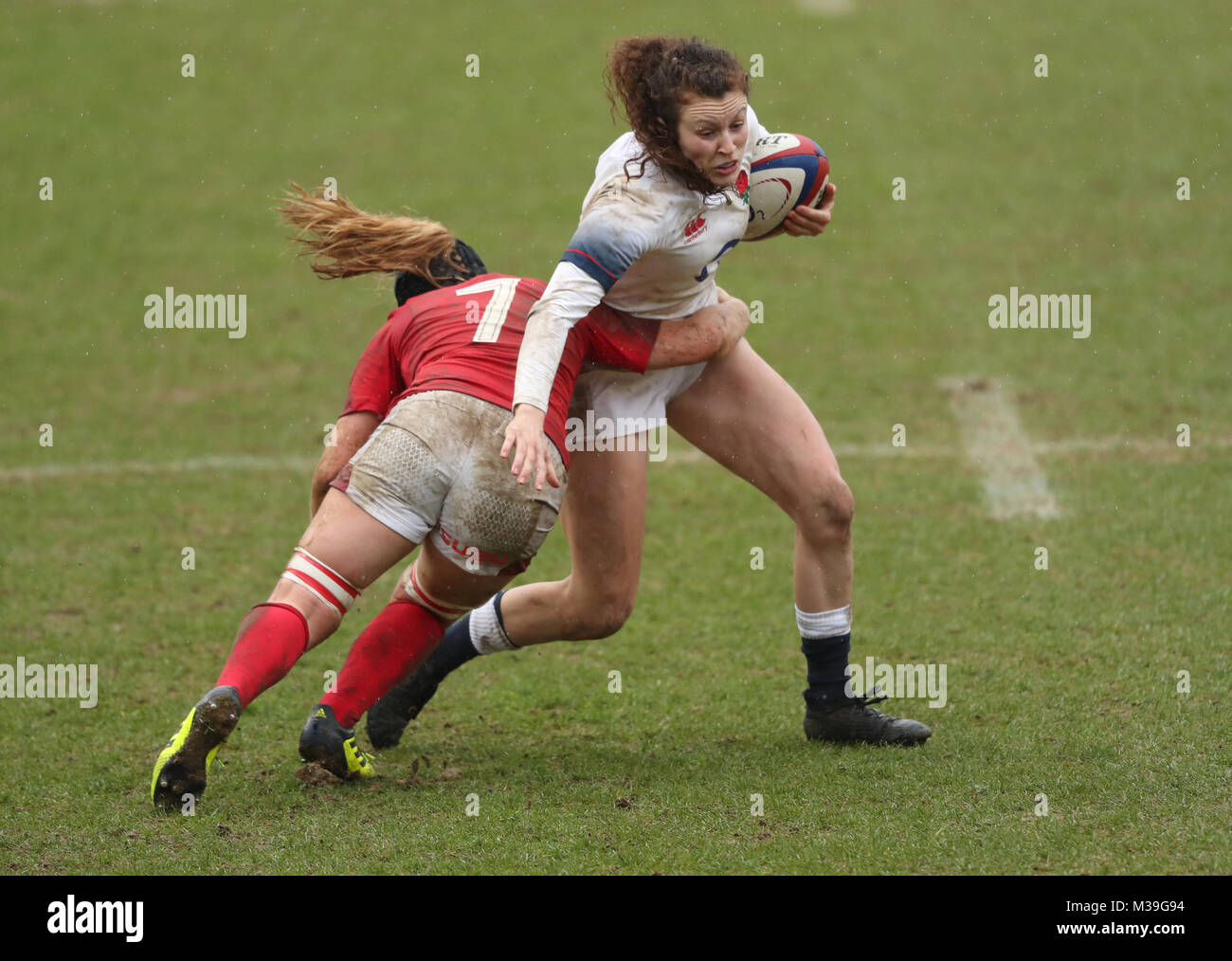 England's Charlotte Pearce (right) is tackled by Wales' Beth Lewis during the NatWest Women's 6 Nations match at Twickenham Stoop, London. Stock Photo