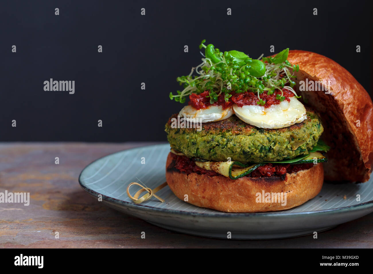 Vegetarian burger made of green pea, butter beans and spinach with sundried tomato pesto and