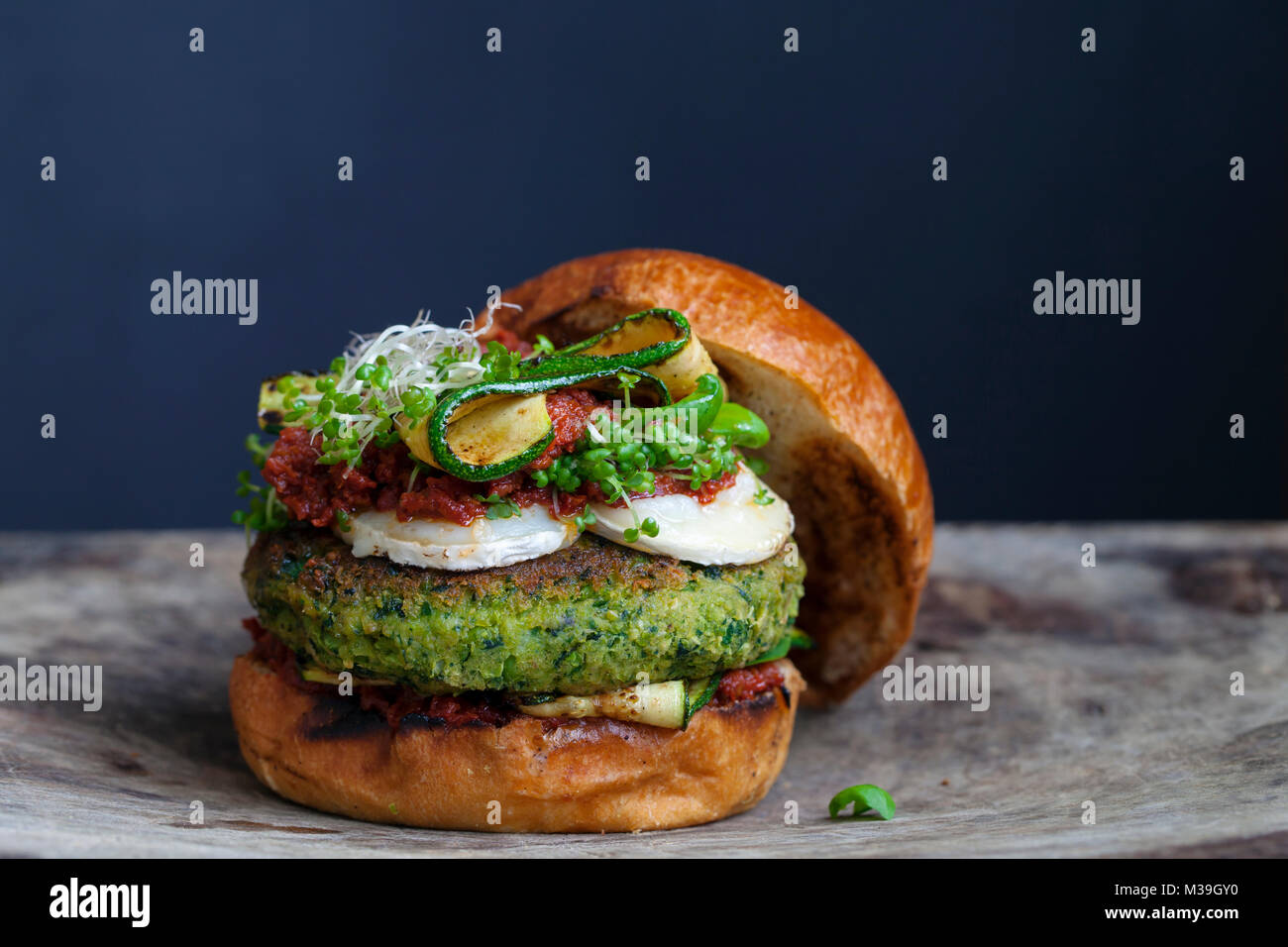 Vegetarian burger made of green pea, butter beans and spinach with sundried tomato pesto and