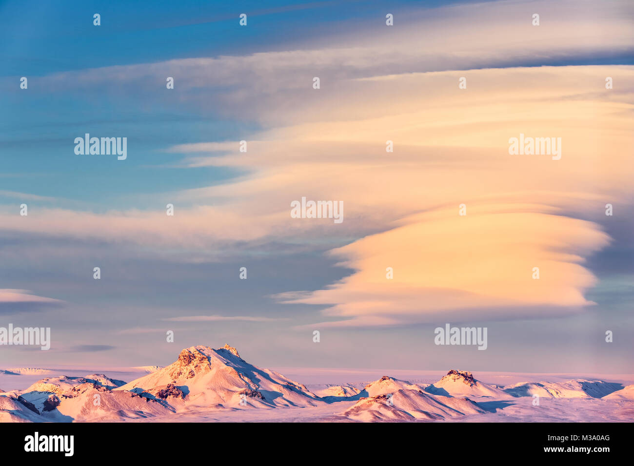 Icelandic landscape with snow-capped mountain peaks and spectacular cloud formations, near Gullfoss, at sunset. Stock Photo