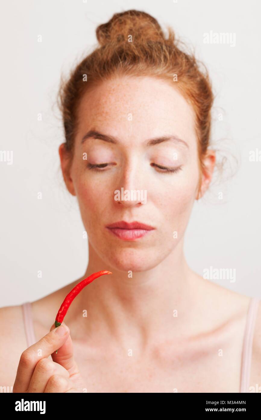 MODEL RELEASED. Woman holding red chili pepper Stock Photo Alamy