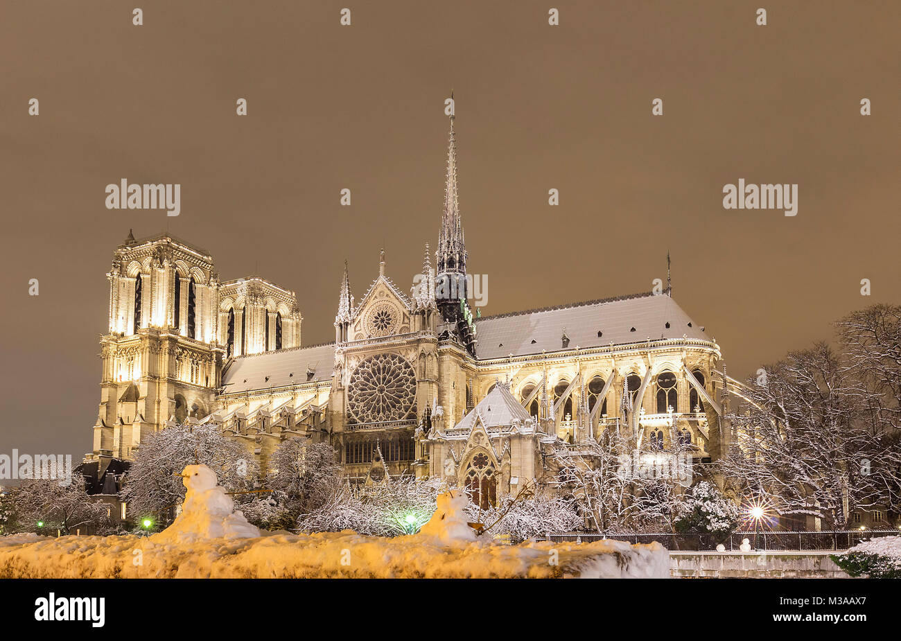 The Notre Dame cathedral in winter and snowmen in the foreground, Paris