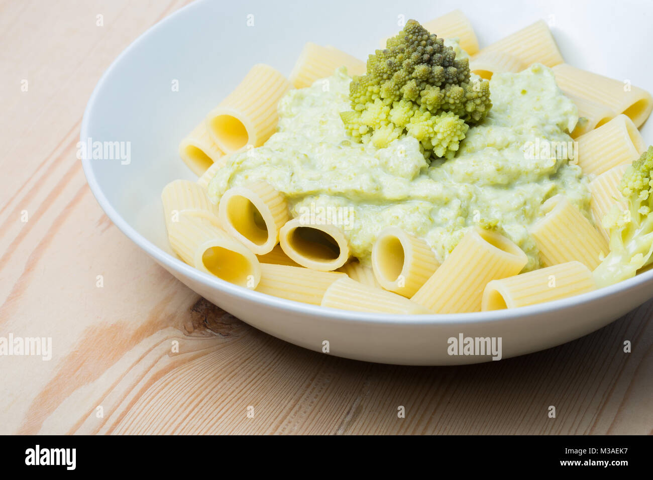 Pasta with Romanesco broccoli cabbage and mozzarella. On rustic
