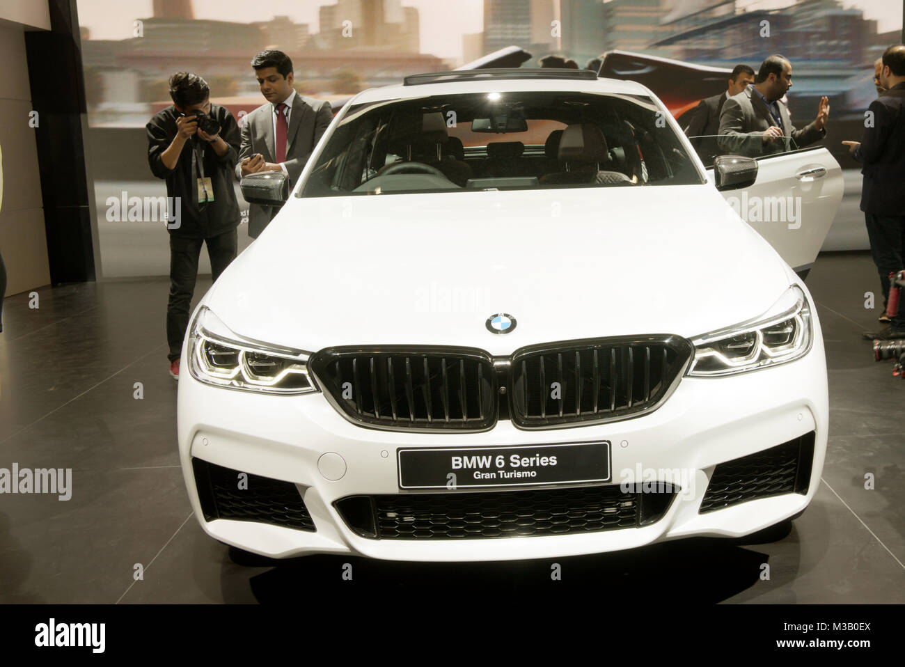 Greater Noida, India. 9th February 2018. Visitors find out more about the BMW 6GT M Sport car on display at the Auto Expo 2018 at India Expo Mart in Greater Noida, India. The Auto Expo is a biennial event and is being held during 9th to 14th February 2018. Credit: Karunesh Johri/Alamy Live News. Stock Photo