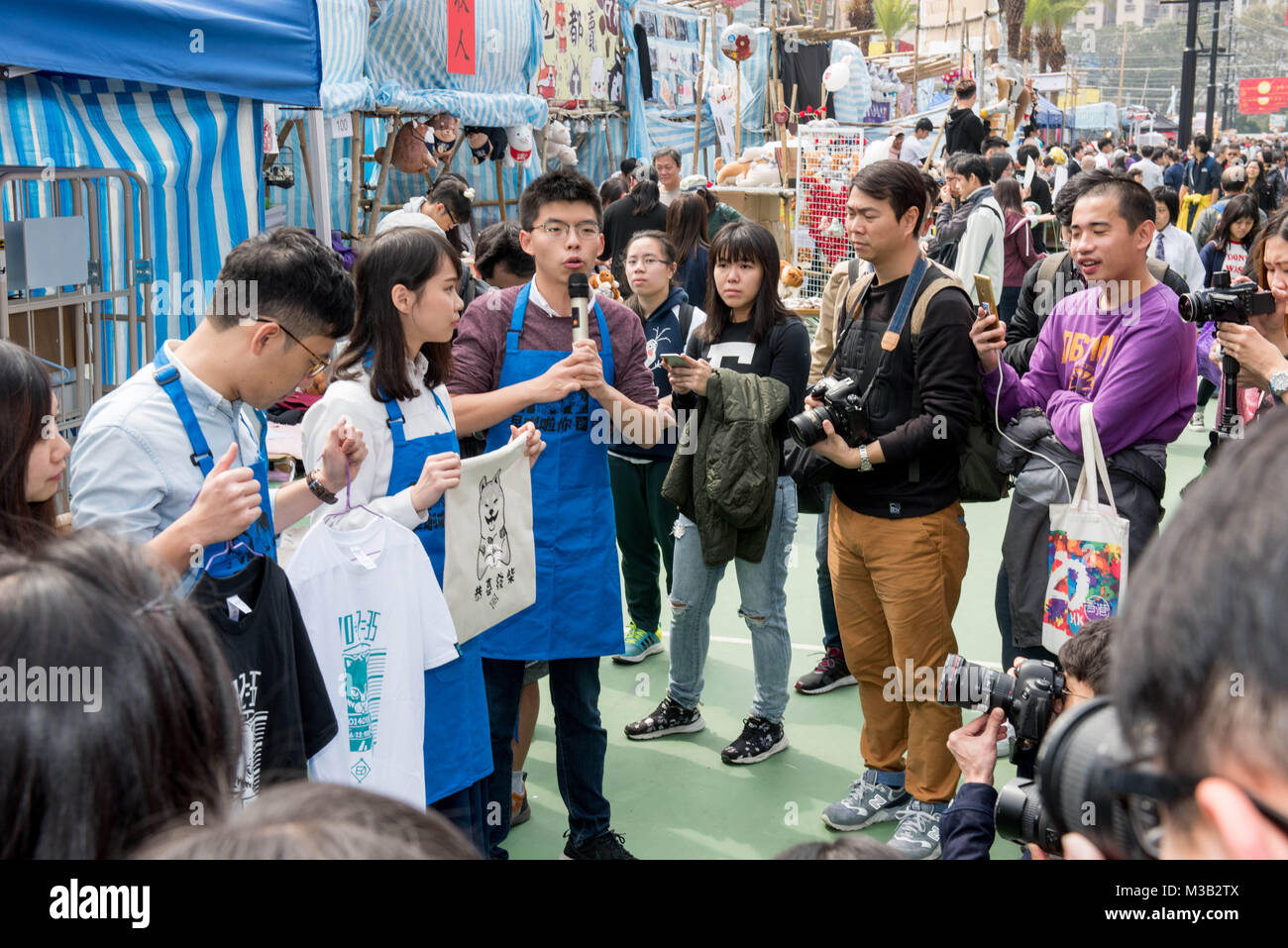 February 10, 2018 - Hong Kong, Hong Kong SAR, CHINA - HONG KONG SAR: CHINA - February 10, 2018. Hong Kong Lunar New Year Fair opens in Victoria Park. The Chinese New Year fair, traditionally filled with flower and gift stalls, is also home to political parties as they fund raise to continue their work. With up to a million people expected each year, the fair is a perfect venue for the political activists.At the Demosisto stand student activists (LtoR) TIffany Yuen Ka Wai, Nathan Law Kwun Chung (Chairman), Agnes Chow Ting and Joshua Wong show off their merchandise (Credit Image: © Jayne Russell Stock Photo