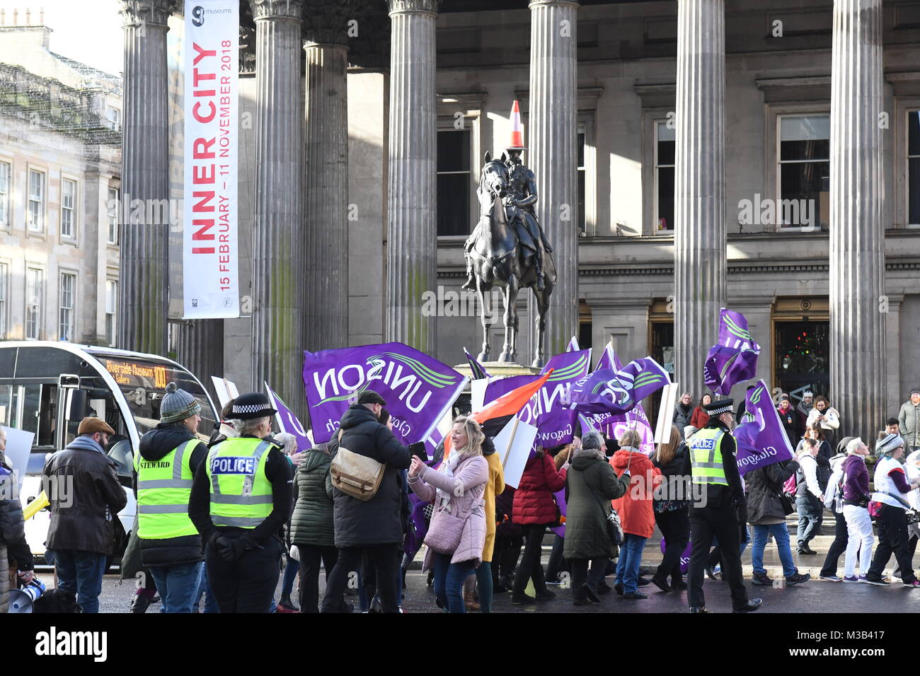 Glasgow, Scotland, UK - 10 February 2018: Women (and men) demonstrating at an equal pay protest in Glasgow, led by women dressed as suffragettes Stock Photo