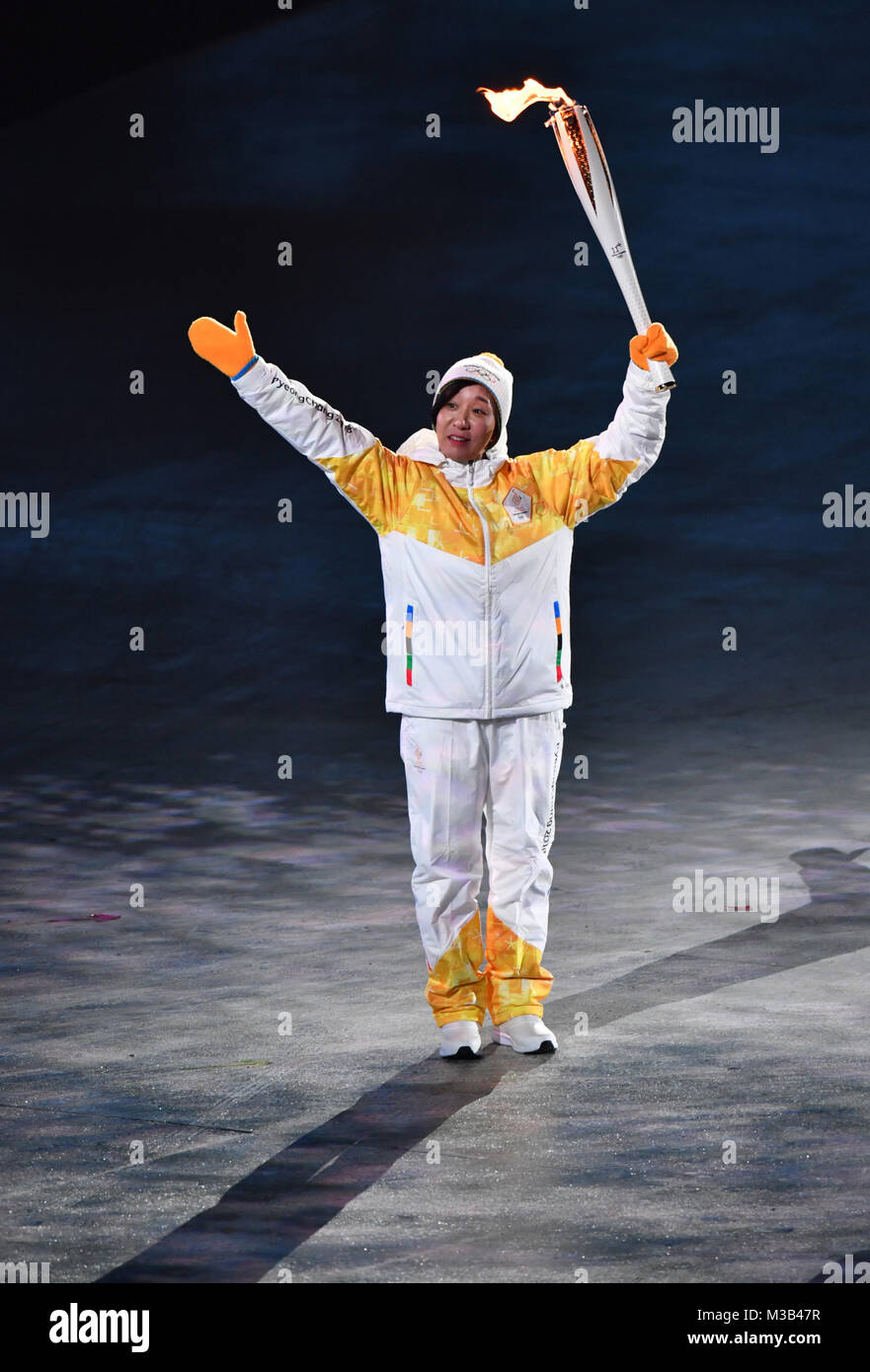 Pyeongchang, South Korea. 9th Feb, 2018. Jong Su Hyon from North Korea carries the Olympic flame into the stadium at the opening ceremony of the Winter Olympics in Pyeongchang, South Korea, 9 February 2018. Credit: Peter Kneffel/dpa/Alamy Live News Stock Photo