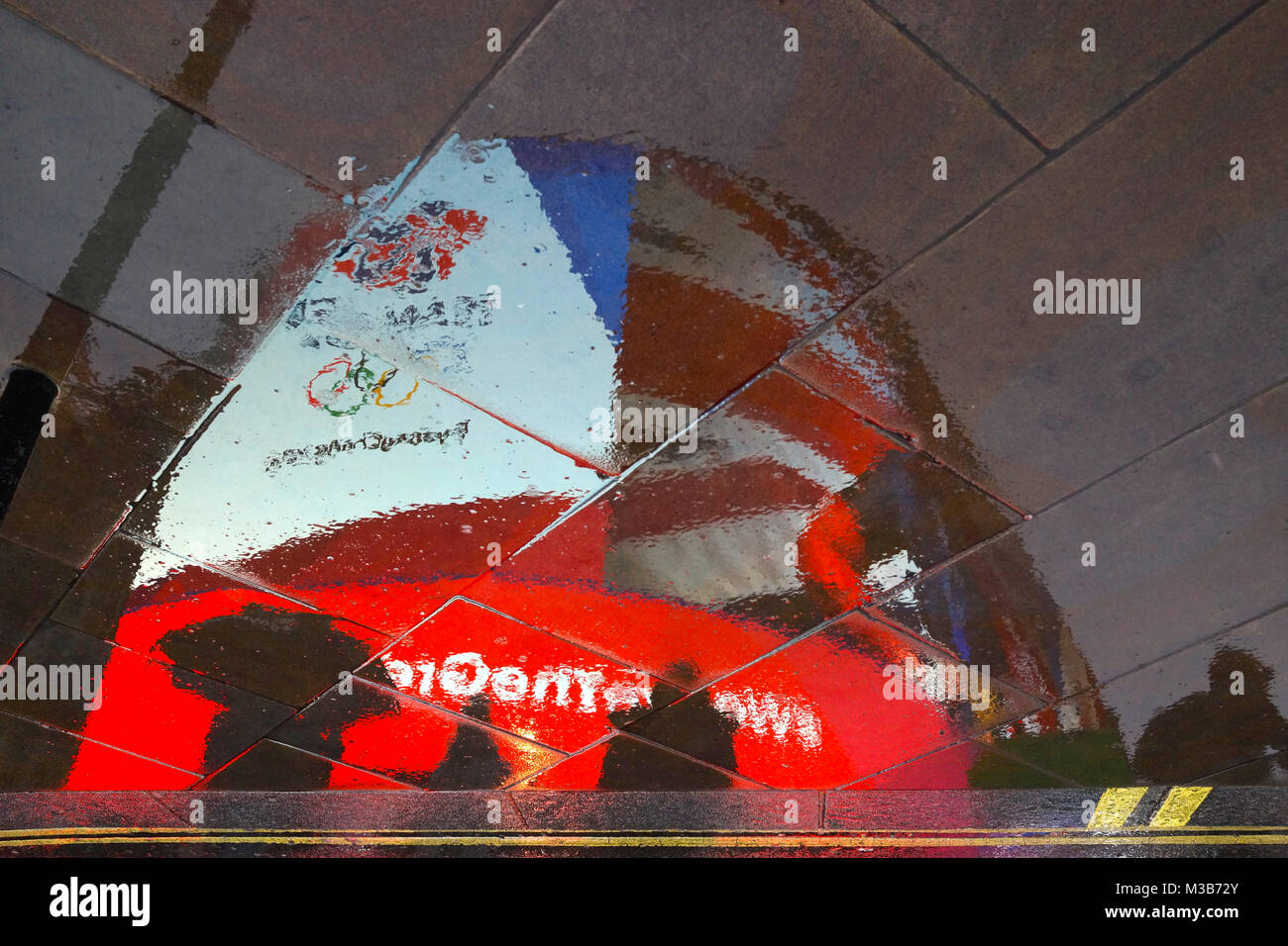 Team GB 2018 winter olympics advertisement reflected in the rain at Piccadilly Circus Stock Photo