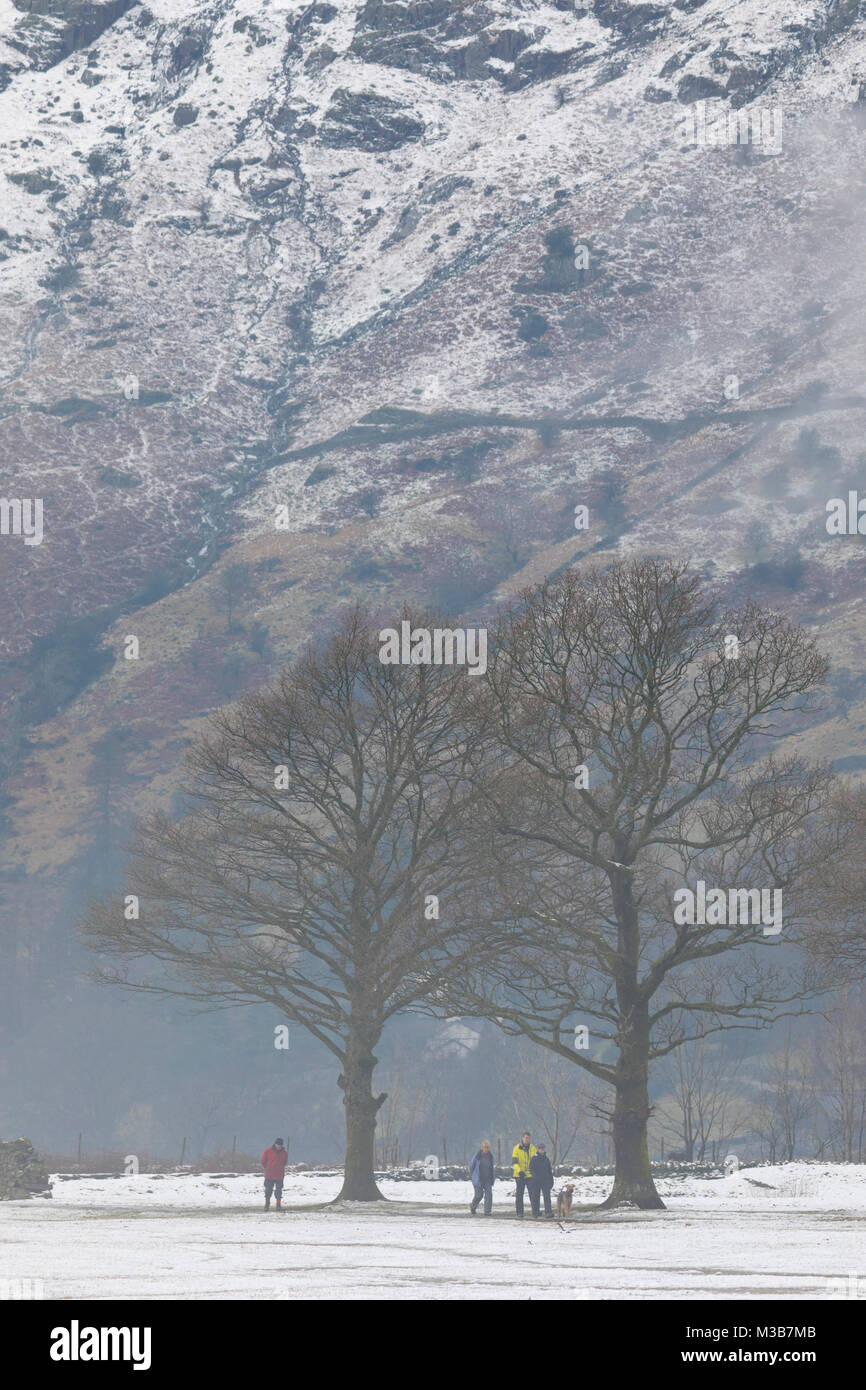 A group of walkers in multicoloured winter clothing walking along the