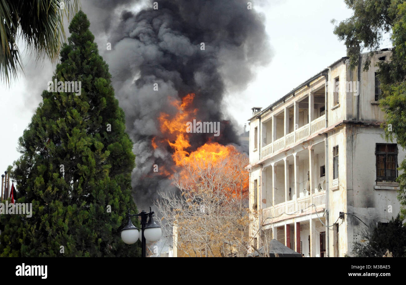 Damascus, Syria. 10th Feb, 2018. Fire and smoke rise after a mortar shell launched by Syrian rebels hit an electricity generator in the Dama Rose Hotel in Damascus, capital of Syria, on Feb. 10, 2018. Credit: Ammar Safarjalani/Xinhua/Alamy Live News Stock Photo