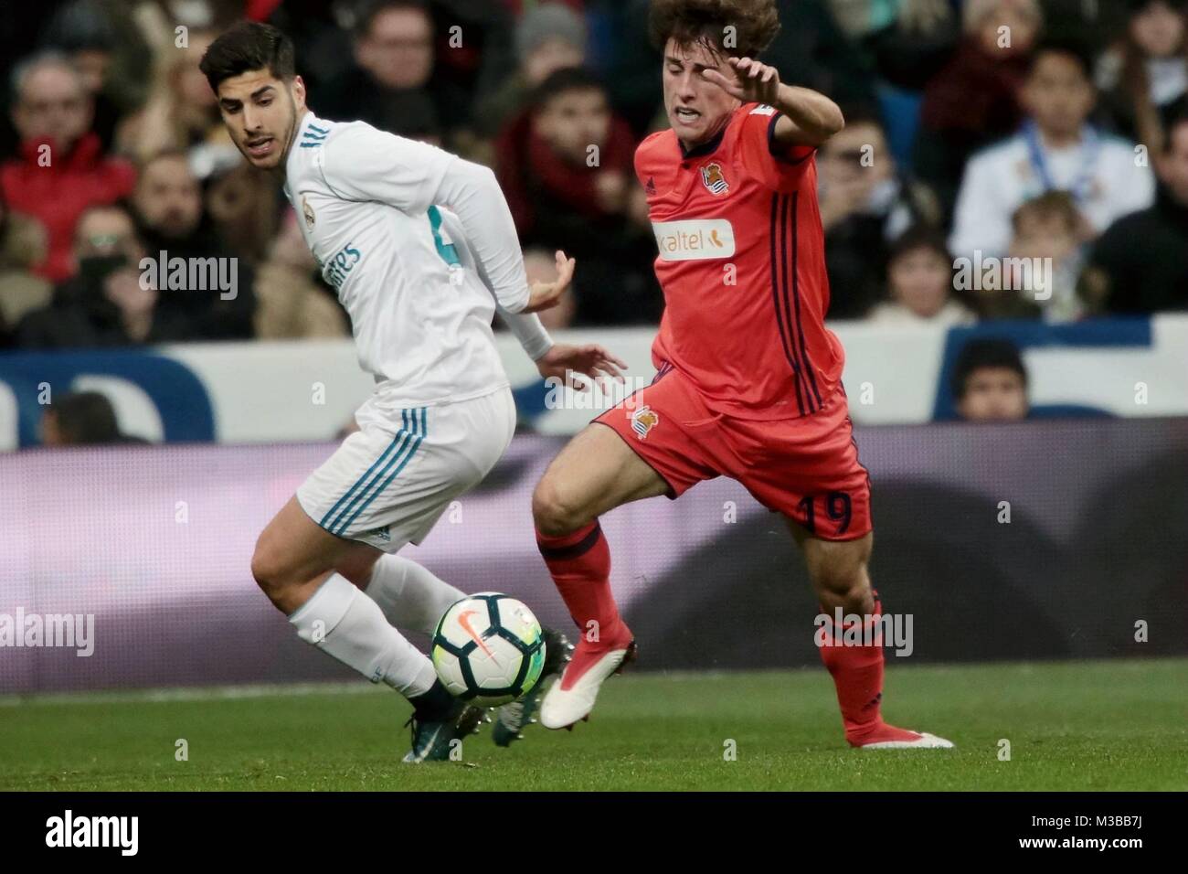 Madrid, Spain. 10th Feb, 2018. Real Madrid's Marco Asesnsio (L) and Real Sociedad's Alvaro Odriozola vie for the ball during a Spanish league match between Real Madrid and Real Sociedad in Madrid, Spain, on Feb. 10, 2018. Real Madrid won 5-2. Credit: Juan Carlos Rojas/Xinhua/Alamy Live News Stock Photo